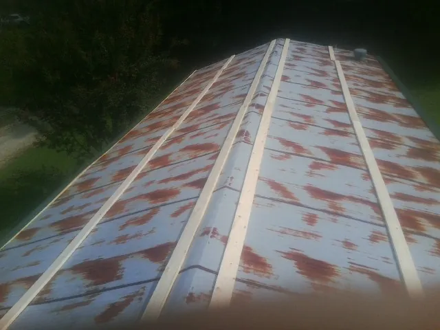 Rusted metal roof panels with new wood purlins before replacement — Storm Damage Roof Repair in San Carlos by Roofing Brothers