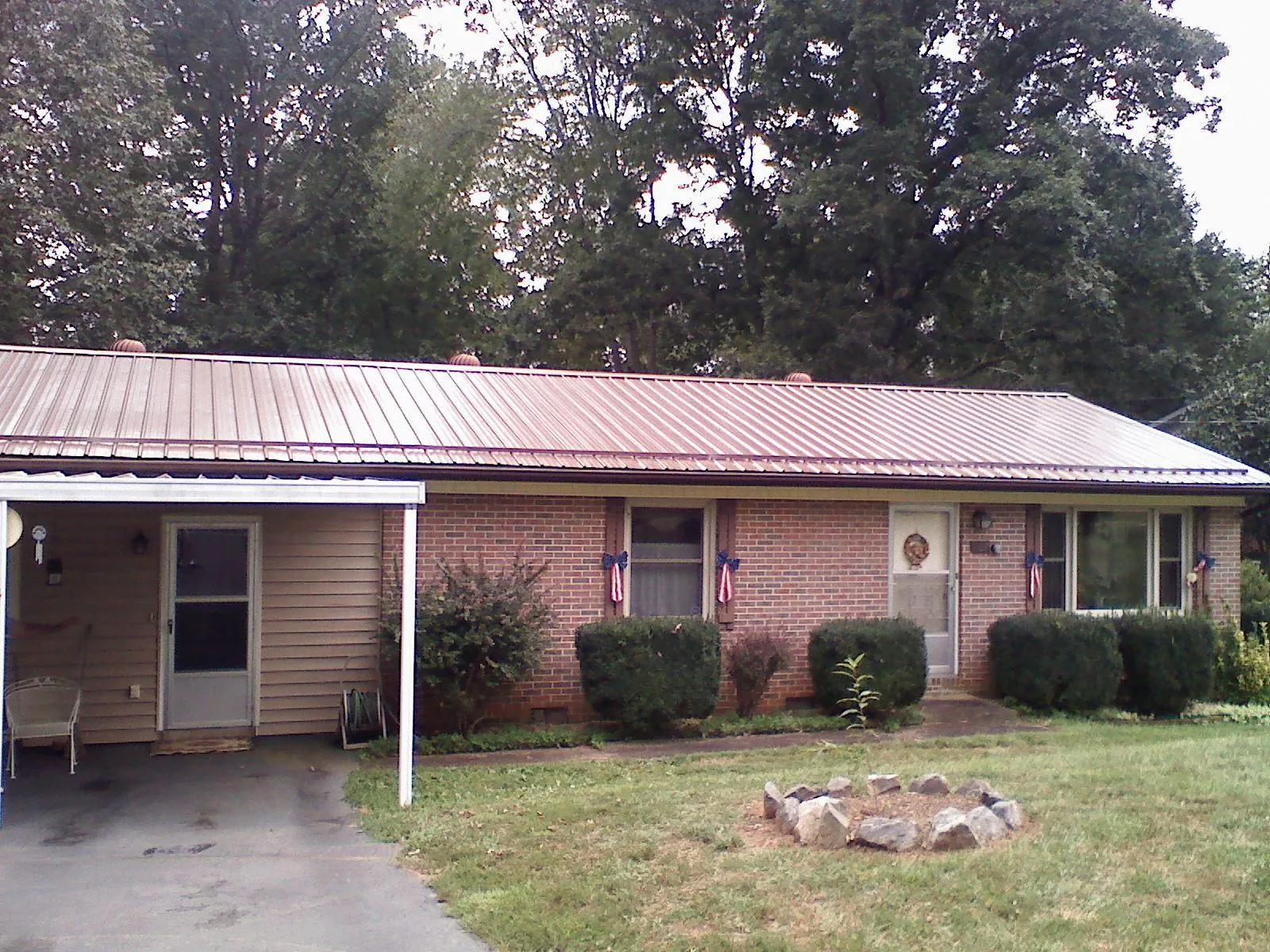 Bronze metal roof and carport on a brick ranch home — Roof Repair work by our crew in San Carlos